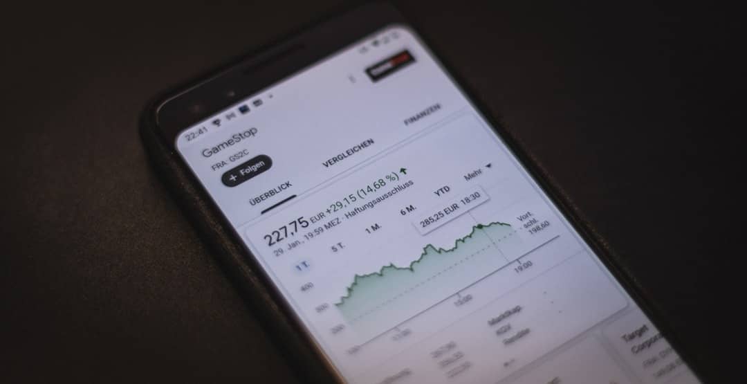 image - Chief of Staff Plattform Smartphone displaying a stock market app with a line chart and price 227,75 EUR on a dark desk surface → informative image showing financial data on mobile.